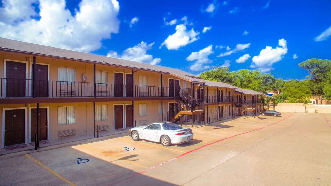 Exterior courtyard and guest rooms at Luxury Inn Dallas