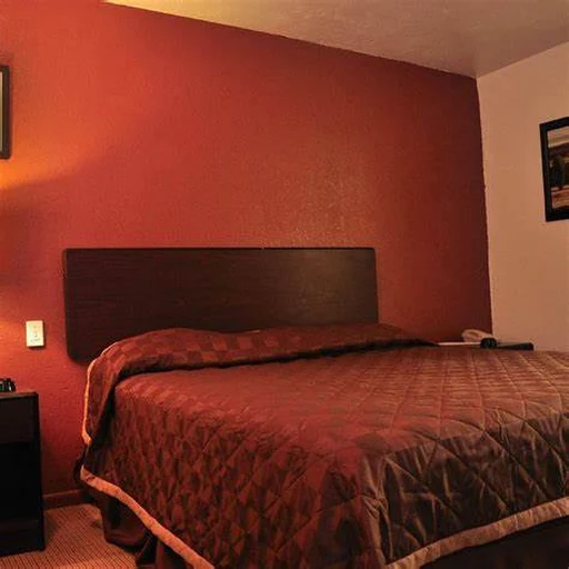 King room with headboard and bedside area
