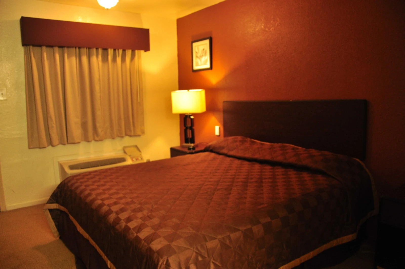 King-bed guest room at Luxury Inn Dallas
