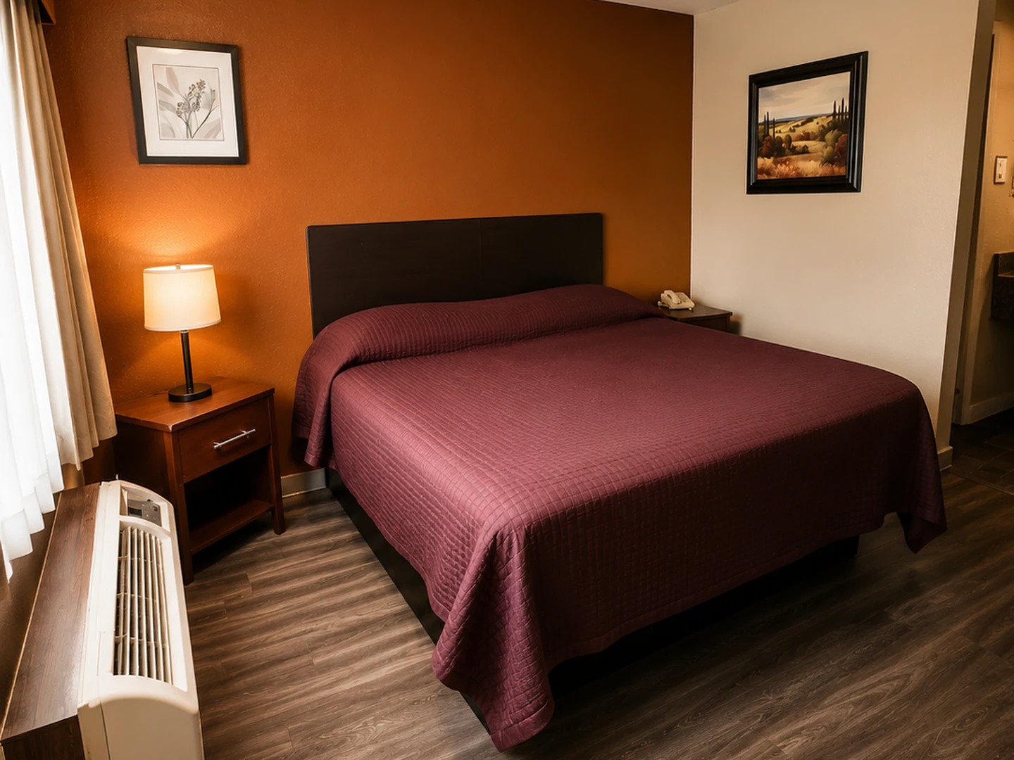 King-bed guest room at Luxury Inn Dallas